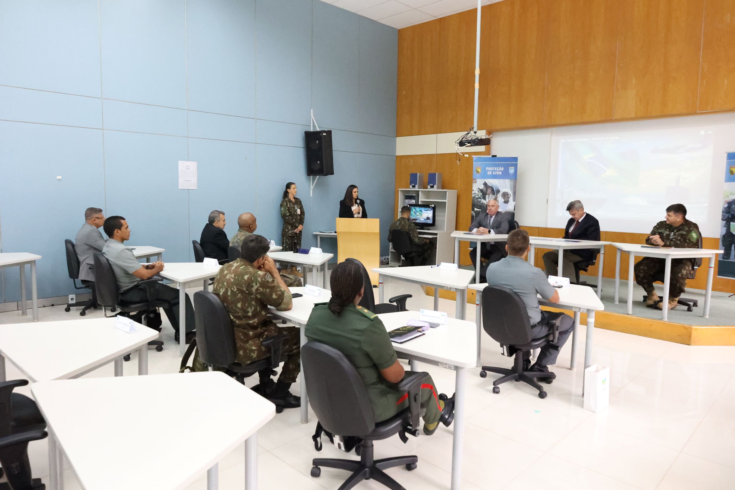 fotografia da sala de conferencia com o elemnto portugues do secretariado permanente paara a cplp a discursar
