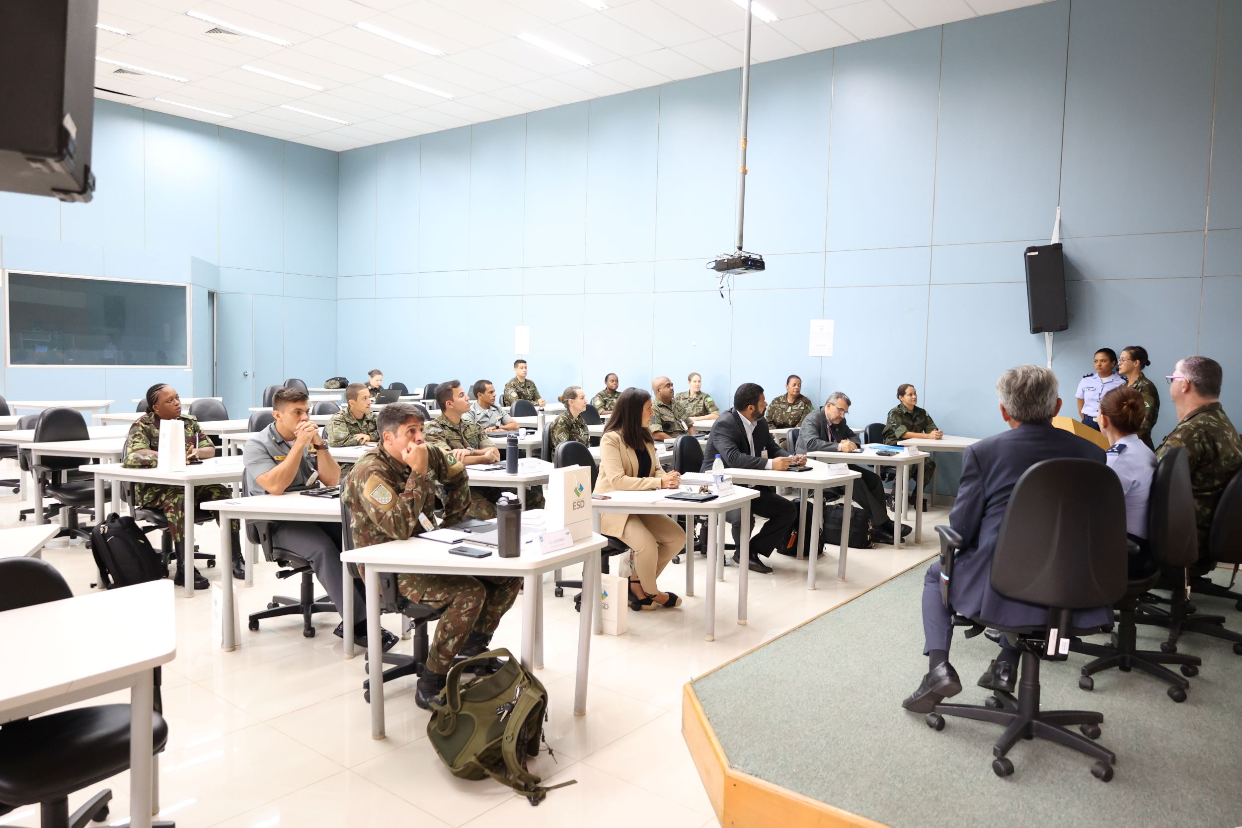 fotografia da sala de conferencia com vários elementos militares e civis
